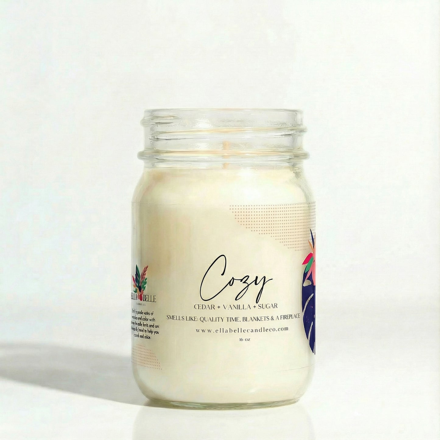 Candle jar labeled 'Cozy' with a minimal design on a clear background