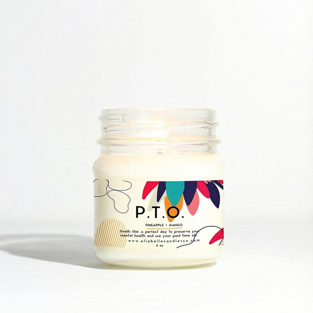 Candle in a glass jar labeled P.T.O. with a colorful label on a white background