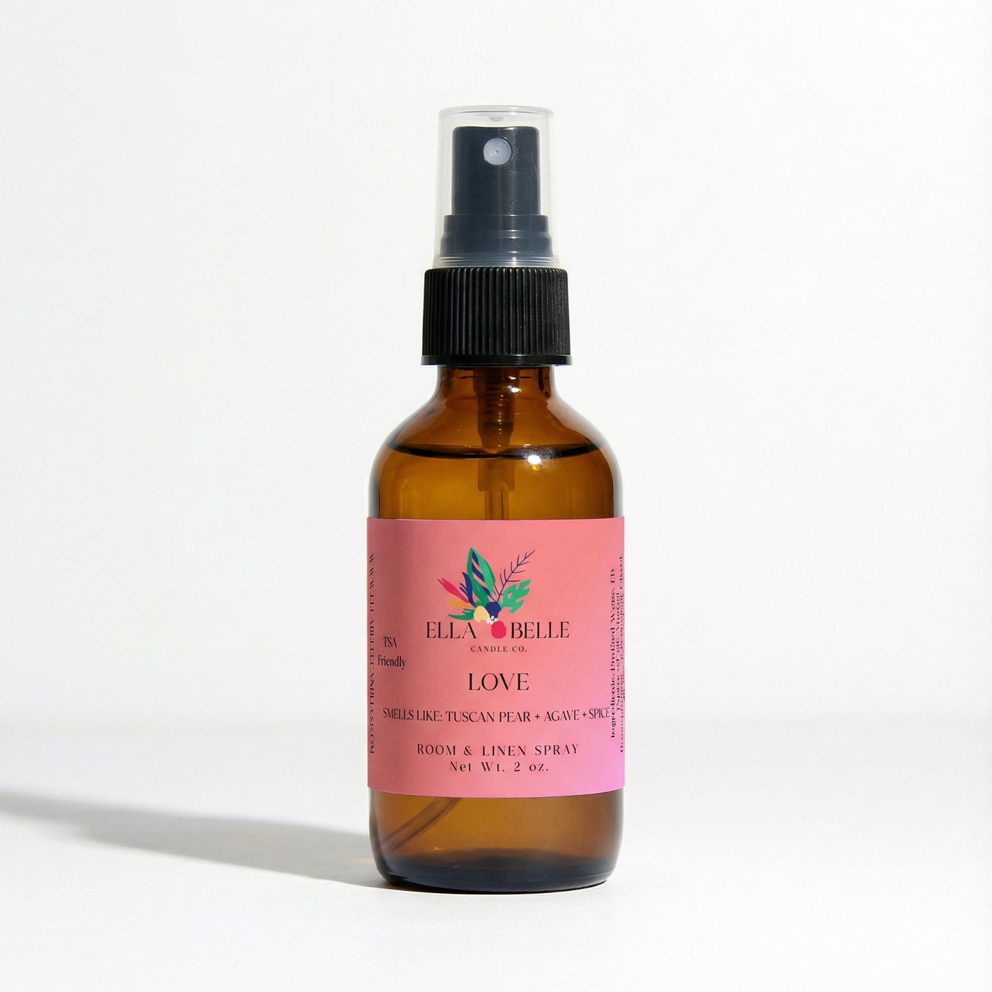 Brown spray bottle with pink label on a white background