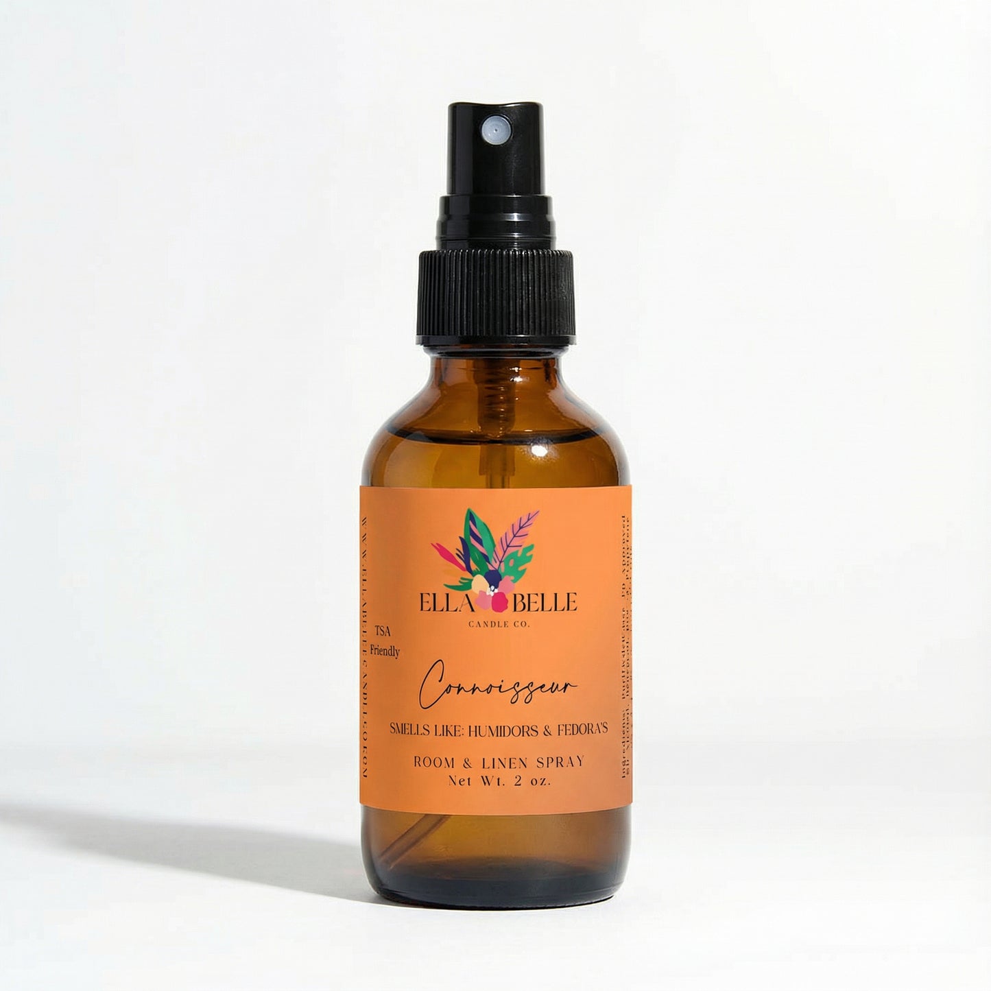 Brown glass bottle with orange label featuring 'Ella Belle Candle Co.' brand on a white background