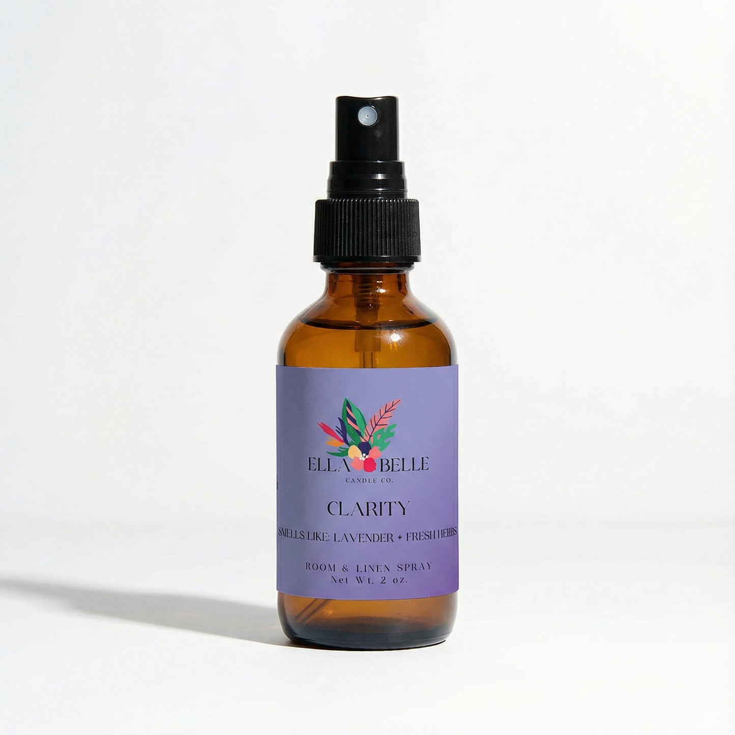 Brown spray bottle with purple label on a white background