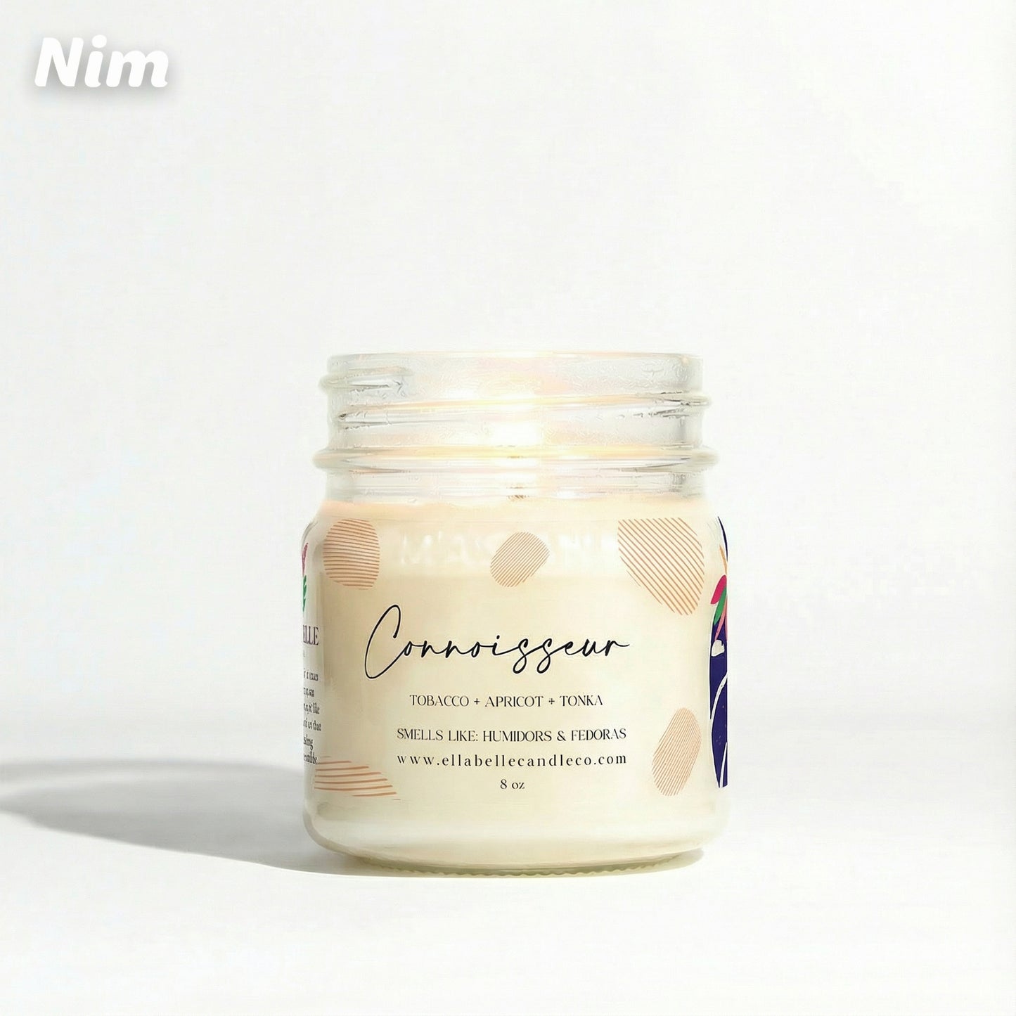 Candle jar labeled 'Connoisseur' with a decorative label on a white background