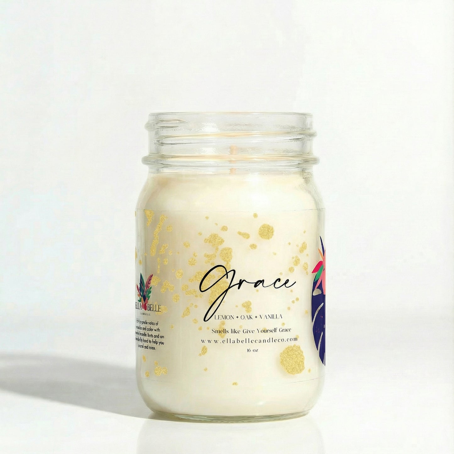 Candle in a glass jar with a decorative label on a white background