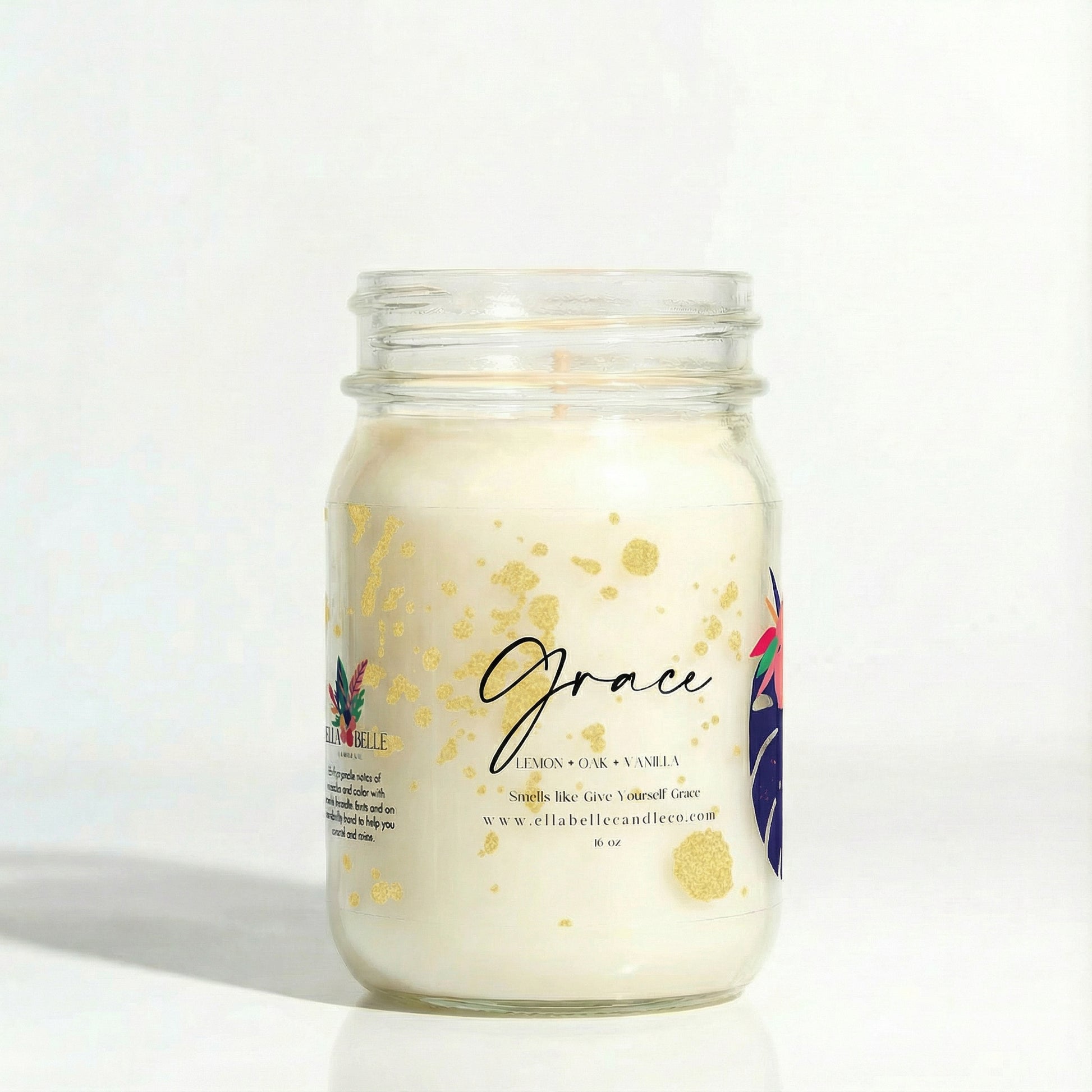 Candle in a glass jar with a decorative label on a white background