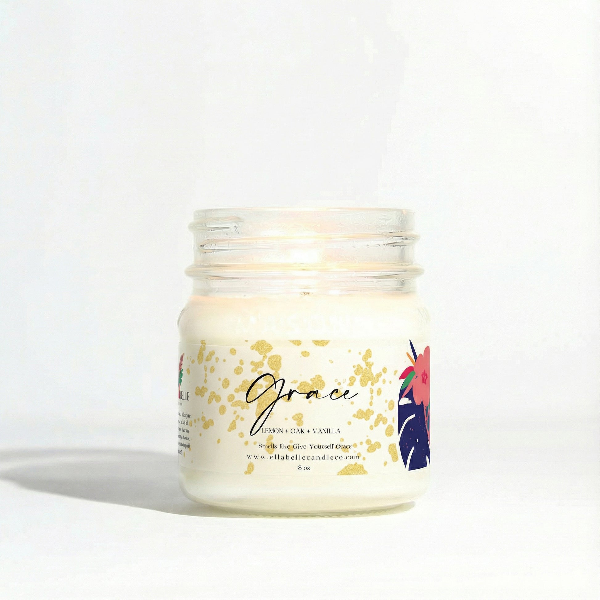 Candle jar with a decorative label on a clear background

