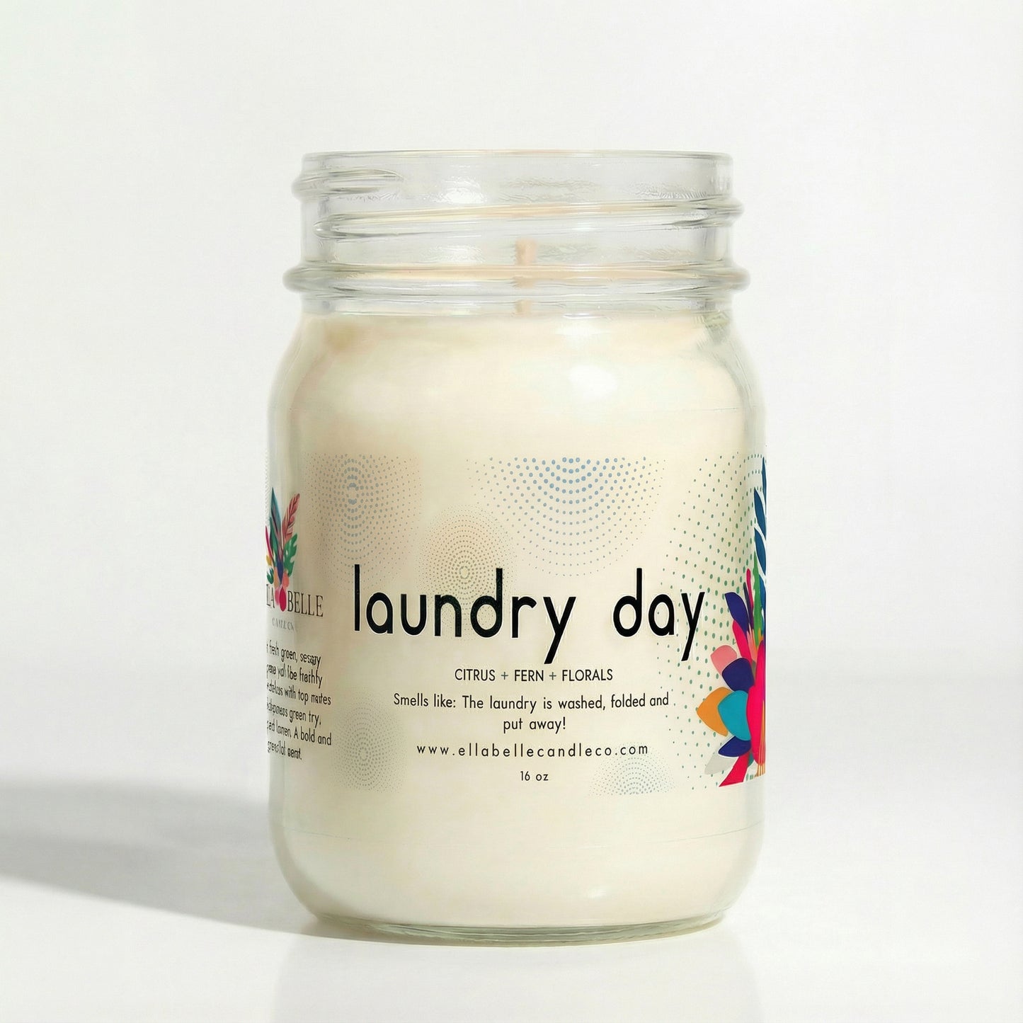 16 oz Glass candle jar labeled 'laundry day' with colorful design on a white background.