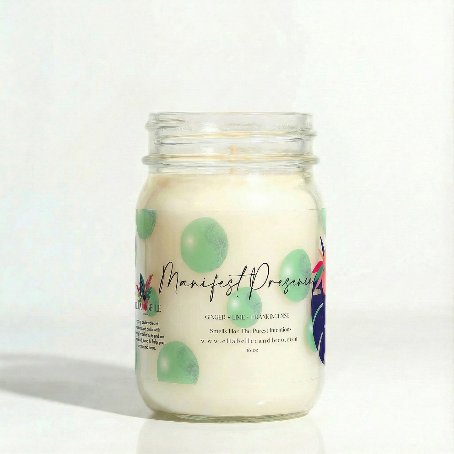 Candle jar labeled 'Manifest Presence' with a decorative label on a white background
