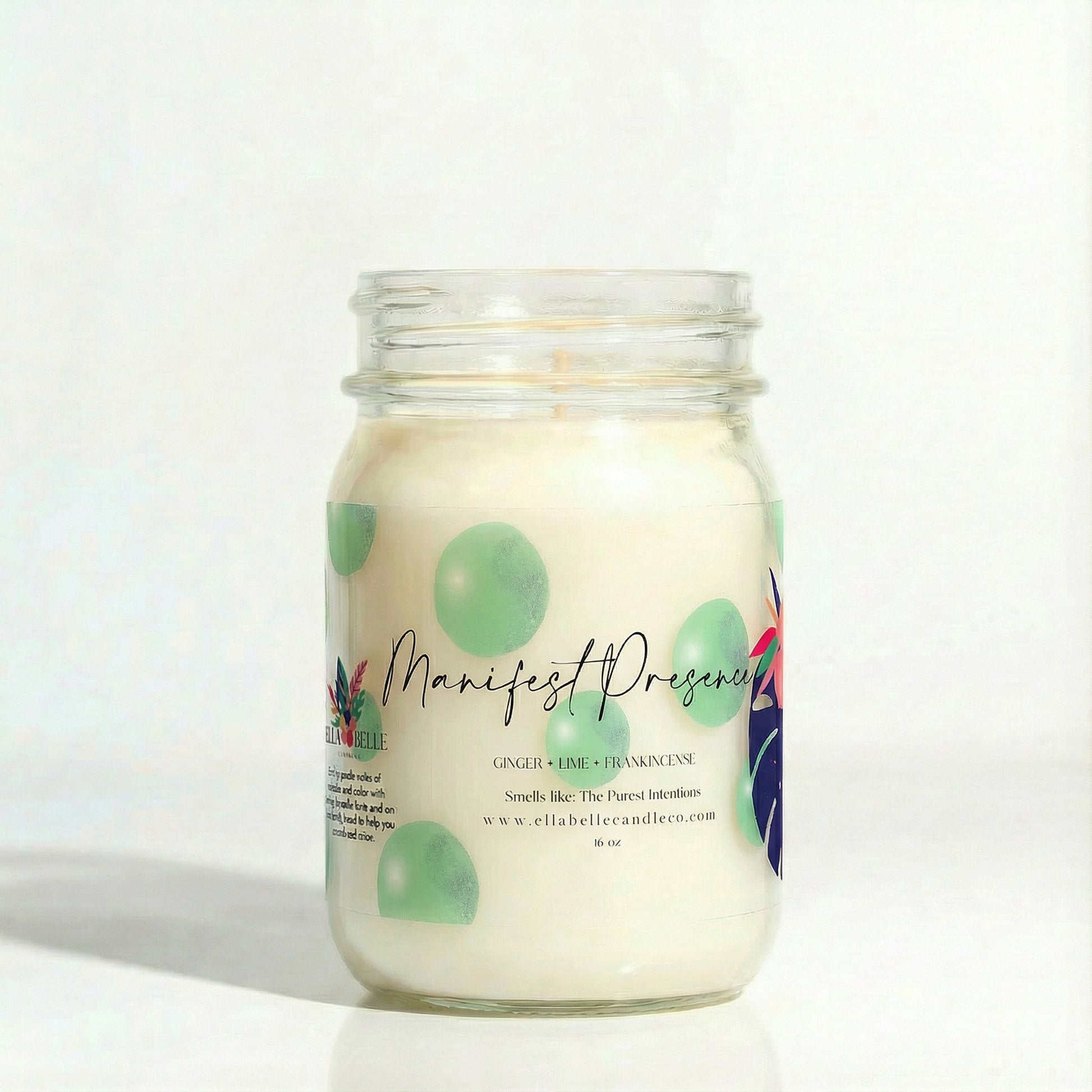 Candle jar labeled 'Manifest Presence' with a decorative label on a white background