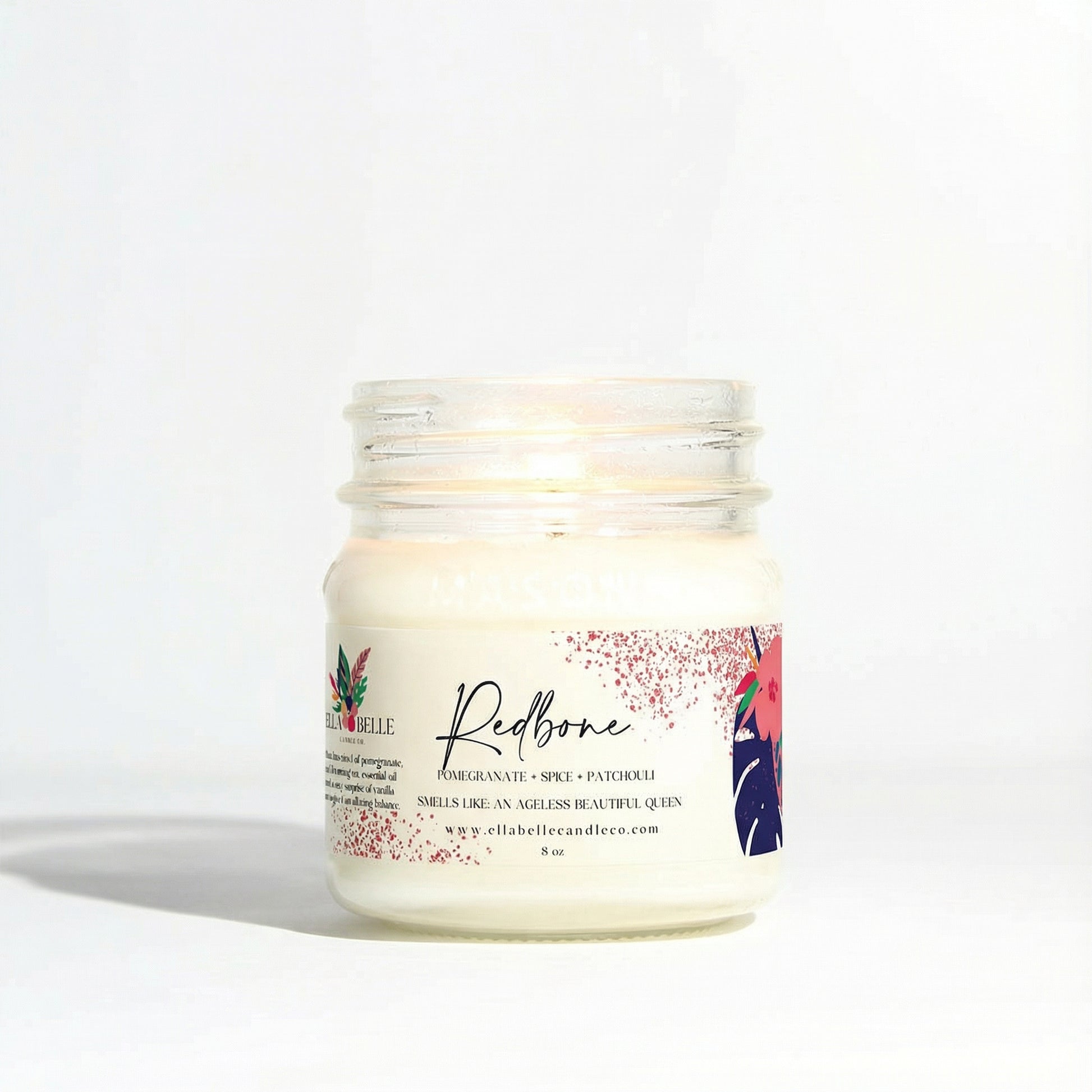 Candle jar with a decorative label on a white background