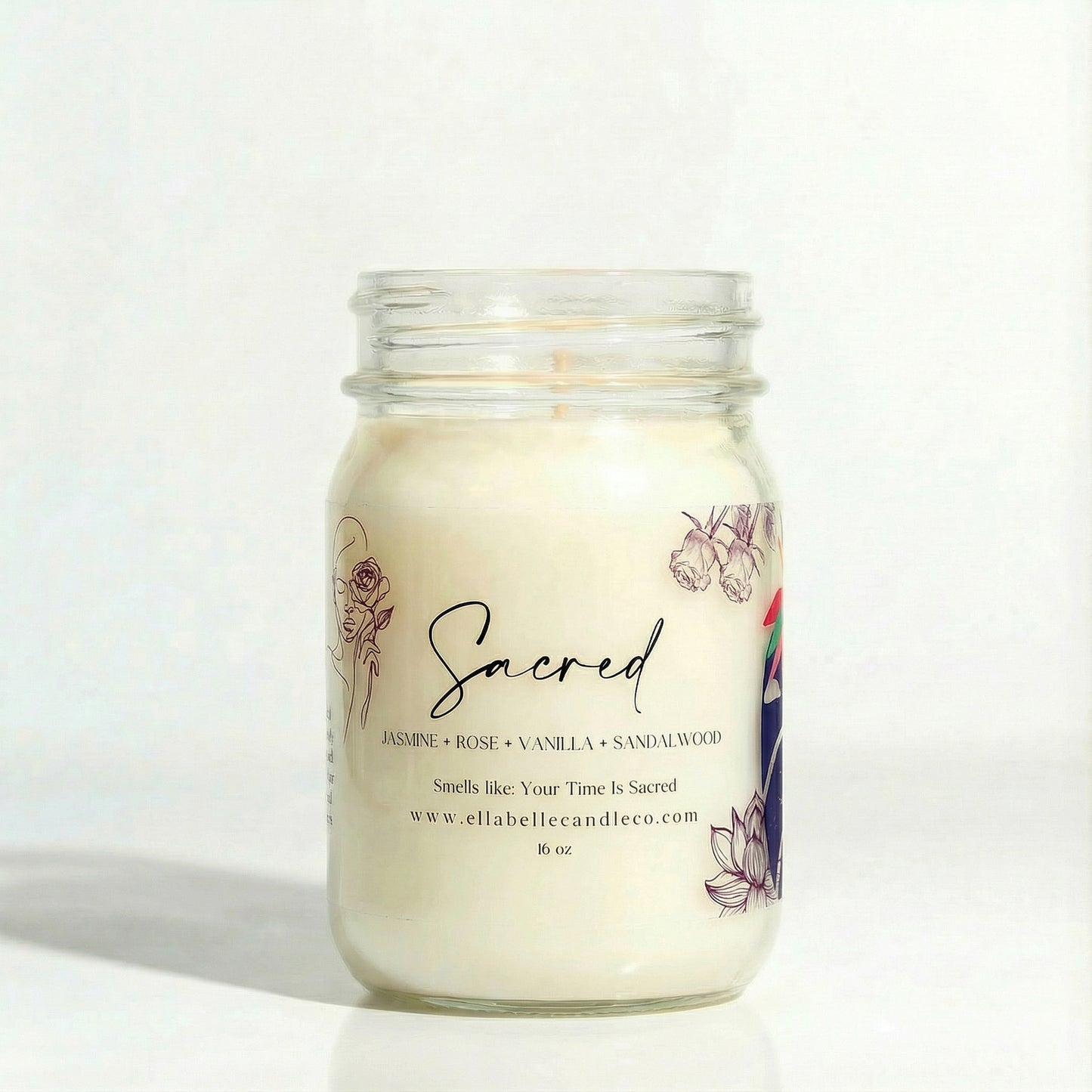 Candle in a glass jar with a decorative label on a clear background