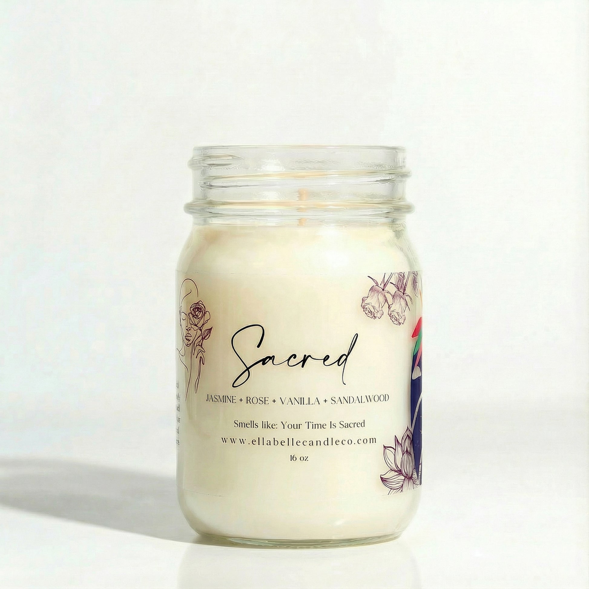 Candle in a glass jar with a decorative label on a clear background