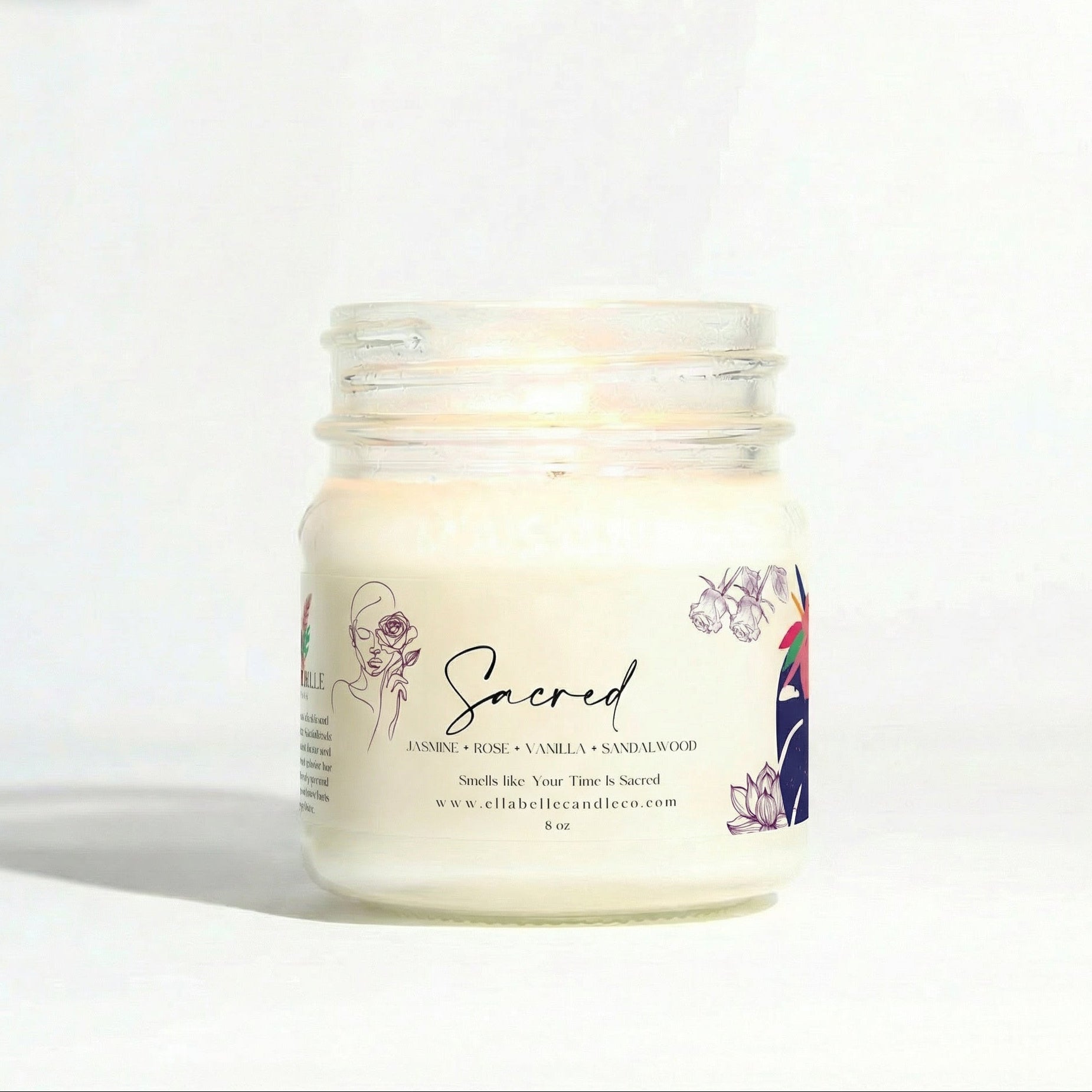 Candle jar labeled 'Sacred' on a white background