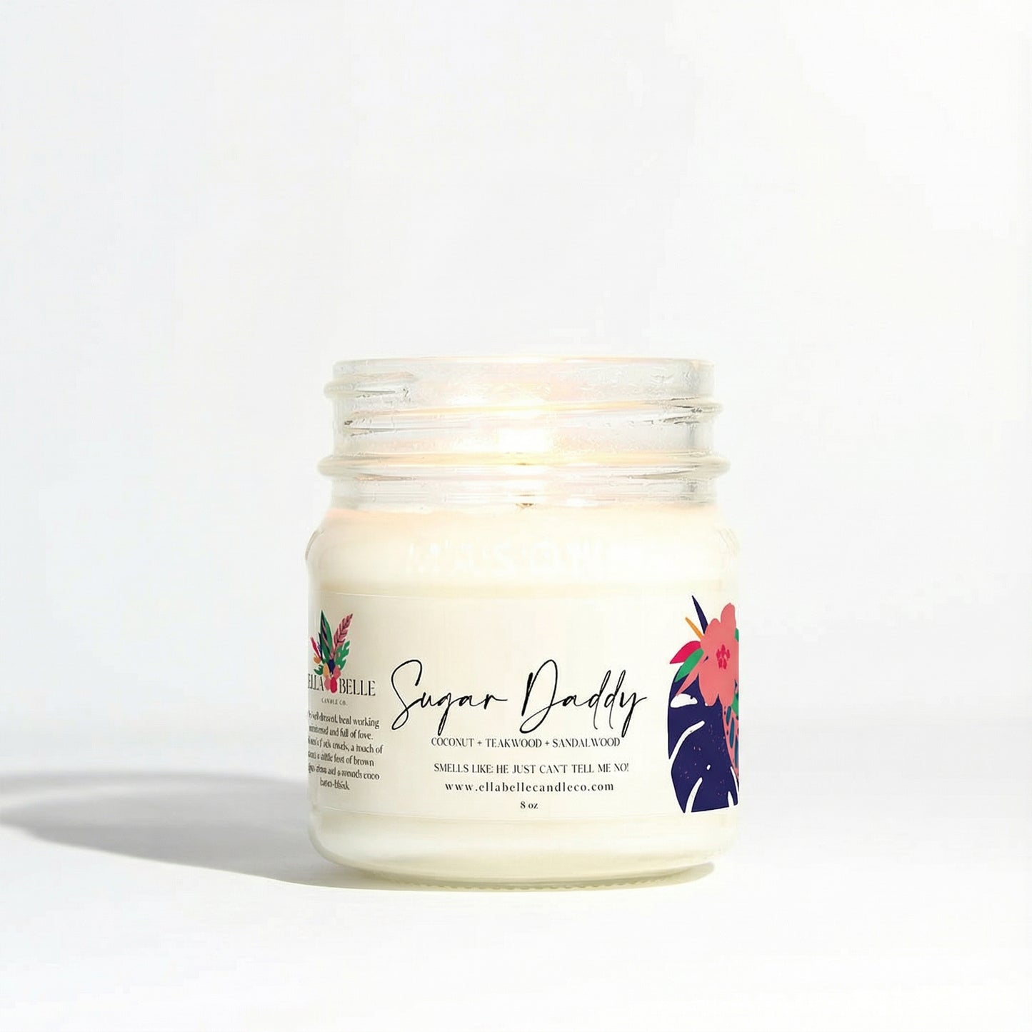 Candle jar labeled 'Sugar Daddy' with floral design on a white background