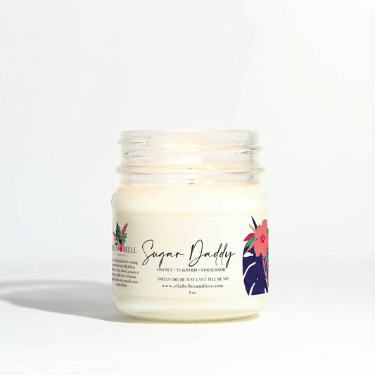 Candle jar labeled 'Sugar Daddy' with floral design on a white background