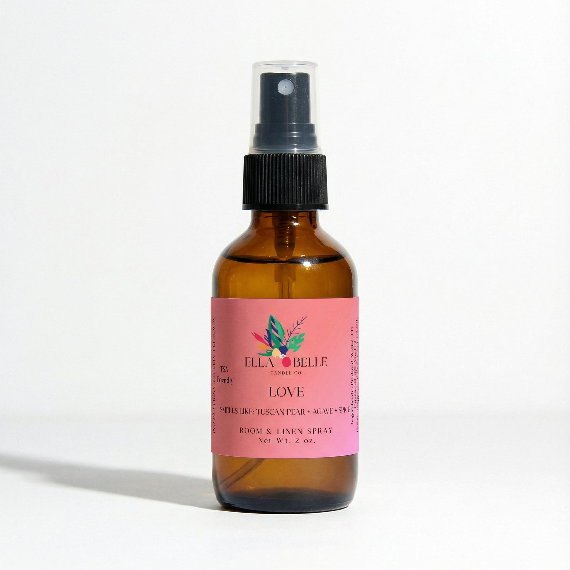 Brown spray bottle with pink label on a white background