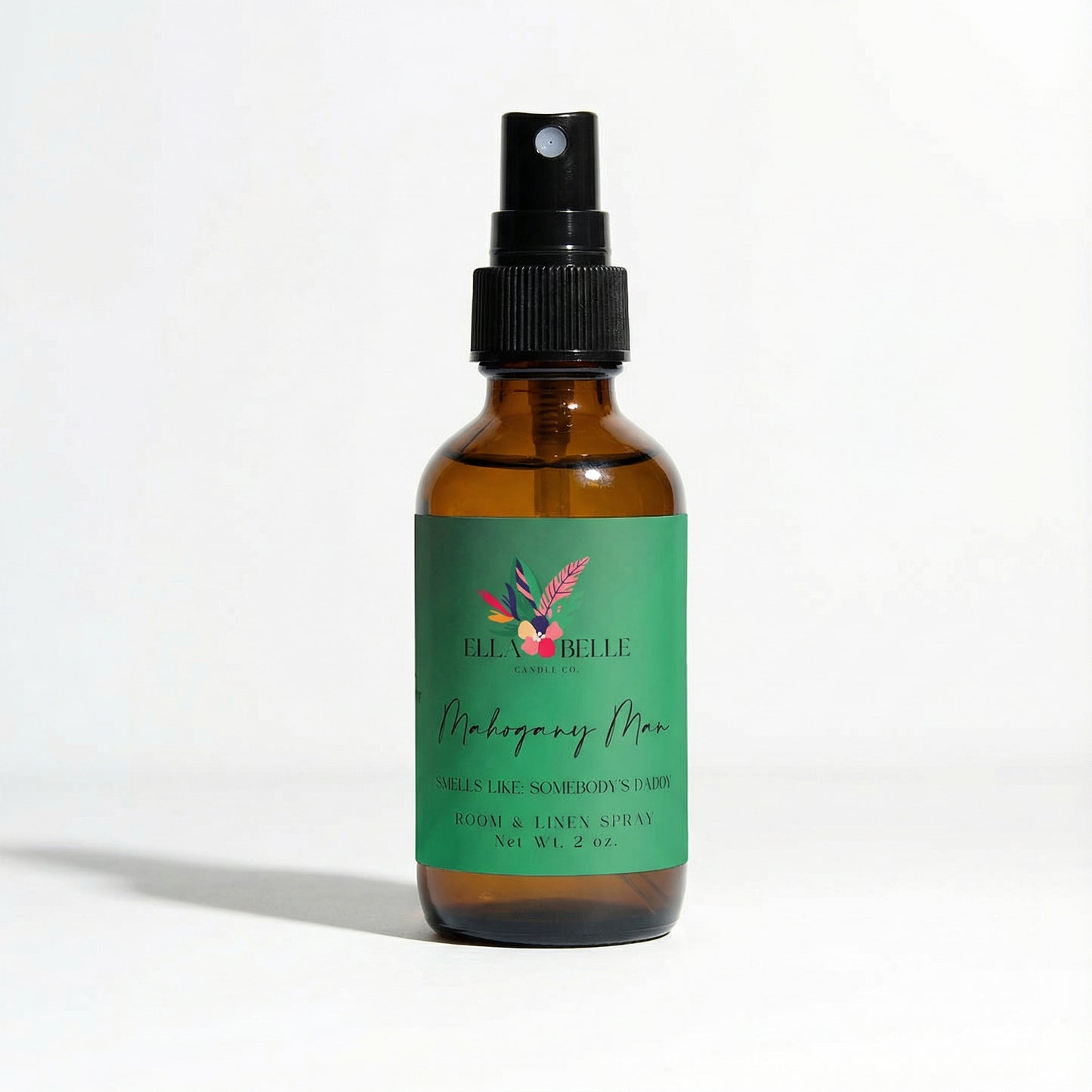 Brown spray bottle with green label on a white background